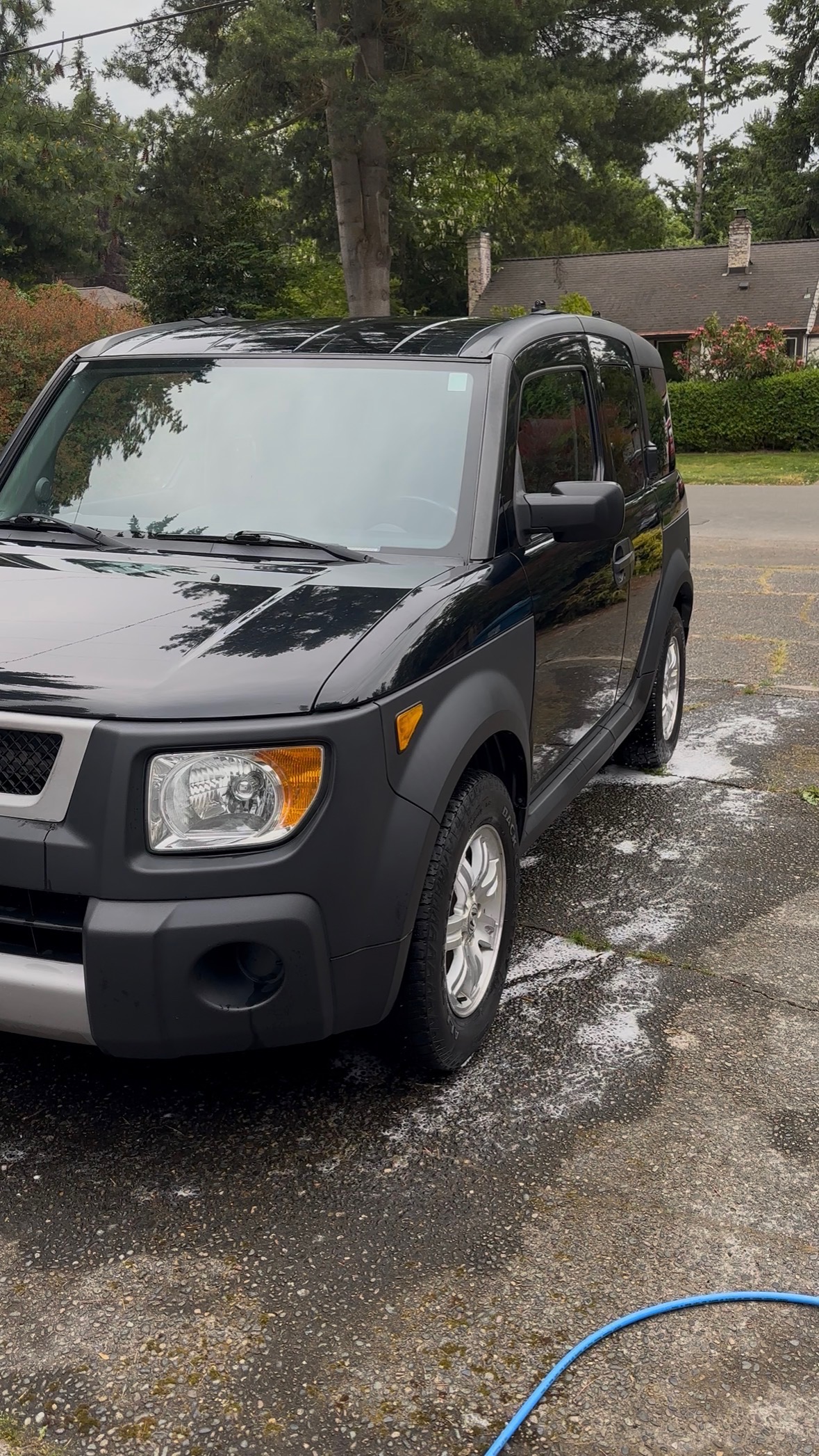 SUV being washed in the driveway